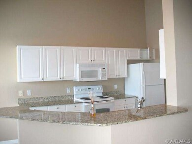Large kitchen with granite countertops and large b