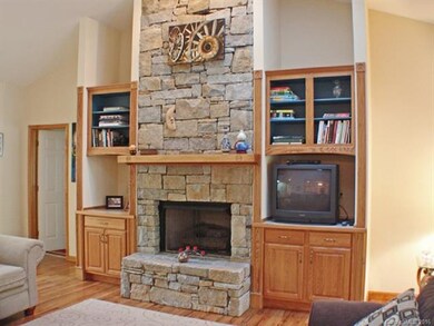 Floor to Celing Rock Fireplace with Built-in Shelv