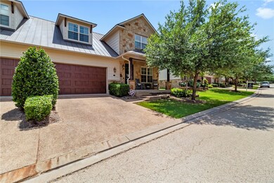 View of front of house featuring stone siding, a m