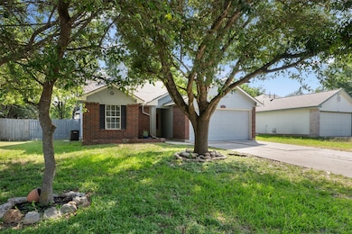View of front of home with brick siding, driveway