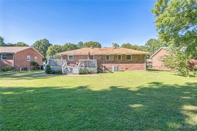 Rear view of property featuring a wooden deck and
