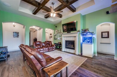 Living room featuring coffered ceiling, dark hardw