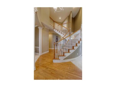 Soaring 2 Story Entry with Sweeping Split Staircas