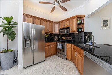 Kitchen featuring stainless steel appliances, tasteful backsplash, crown molding, open shelves, and brown cabinetry