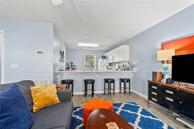 Living room looking into kitchen with bar seating