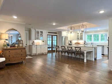 Kitchen space with an inviting chandelier, dark wo