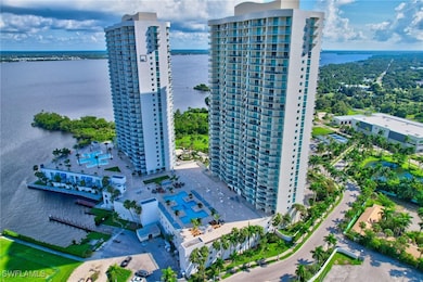 Birds eye view of property with a water view