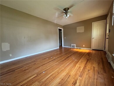Empty room featuring hardwood / wood-style floors and ceiling fan
