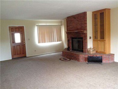 Living room with brick fireplace and built in ligh