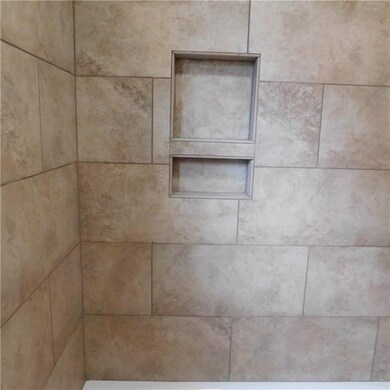 Tiled shower with tub (inset for convenience)