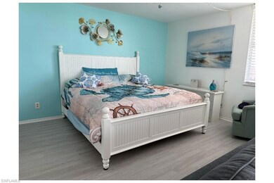 Bedroom with wood finished floors and baseboards