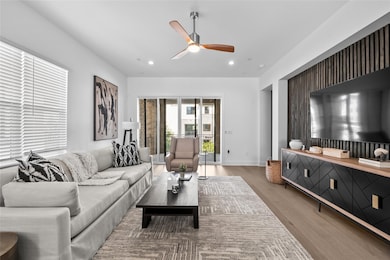 Living area featuring ceiling fan, recessed lighting, and light wood-style floors