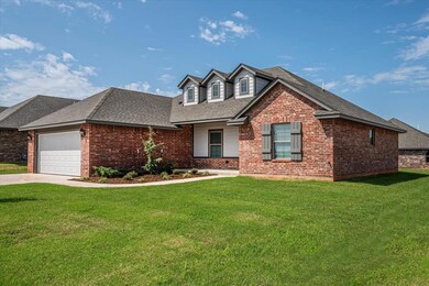 View of front of house featuring roof with shingles, a front lawn, covered porch, and driveway