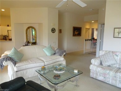 Living room featuring carpet floors and ceiling fa
