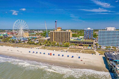 Aerial view featuring a beach view and a water vie
