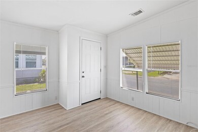 Inside the entryway, abundant windows fill the space with natural light, creating a bright and open welcome.
