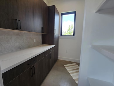 Kitchen with decorative backsplash, dark brown ca