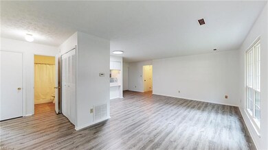 Bedroom featuring multiple windows and light hardw