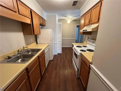 Kitchen featuring a textured ceiling, sink, white 