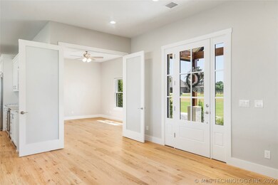 The foyer opens to the study through French doors.