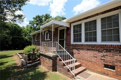 Covered front porch with storm door and decorative
