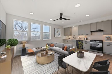 Living area featuring a ceiling fan, light wood f