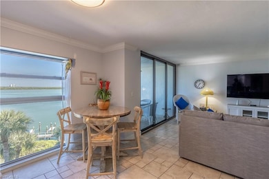 Dining room with crown molding and a water view