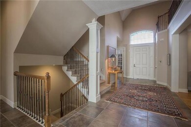 TILE ENTRY WAY, STAIRS OFF TO THE SIDE TO GO UP OR