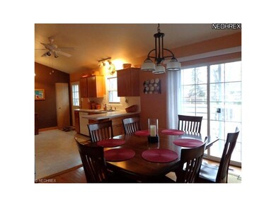 Dining room with wood floor, updated lighting, exi