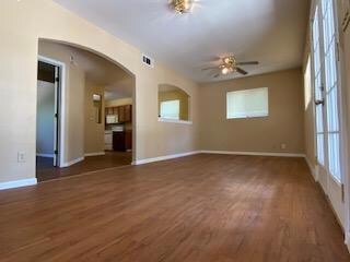 Unfurnished living room featuring wood finished f