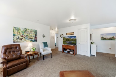 Living room with light carpet and baseboards