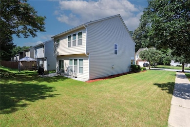 View of side of property with a gazebo and a lawn