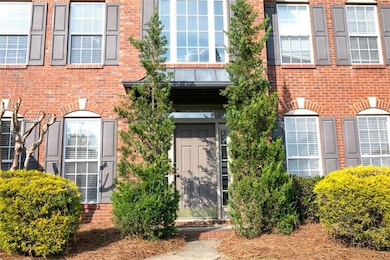 Doorway to property featuring brick siding