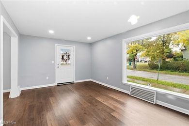 Entrance foyer featuring dark wood-type flooring, recessed lighting, and an AC wall unit