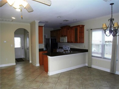 Kitchen with granite counters, appliances and bar