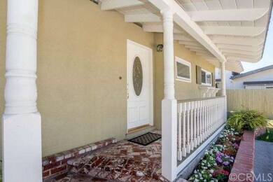 Used brick steps and covered front entry are some 