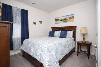Bedroom featuring light colored carpet
