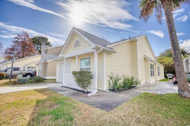 View of property exterior with a lawn and a garage