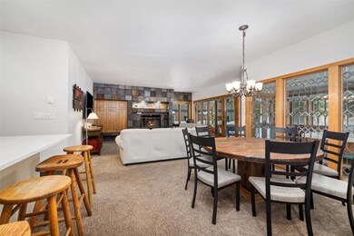 Dining area featuring a large fireplace, light car