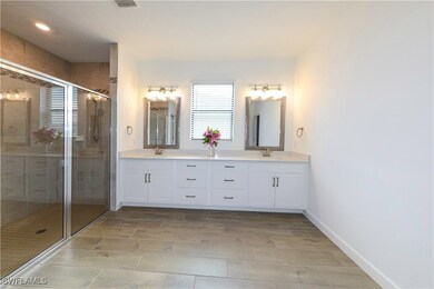 Full bath featuring double vanity, a stall shower