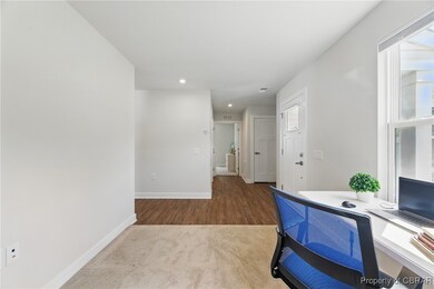 Office area with carpet floors, baseboards, recess