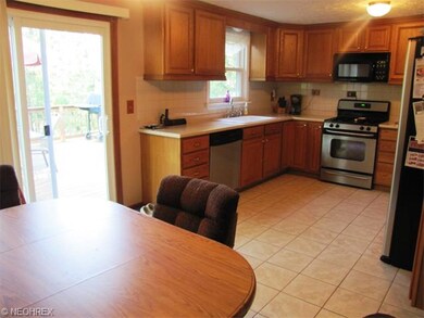 eat in kitchen with handsome cabinetry and stainless steel appliances