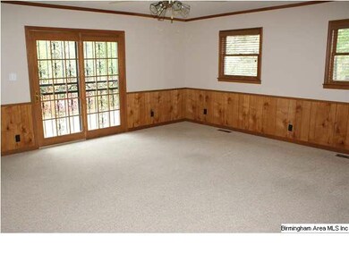 Den with ceiling fan, wainscotting, huge walk-in c