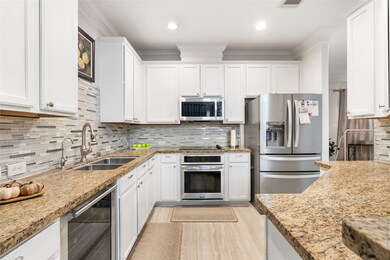 The open-concept kitchen, featuring high-end appli