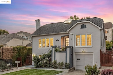 View of front of property featuring stucco siding, an attached garage, a chimney, driveway, and a shingled roof