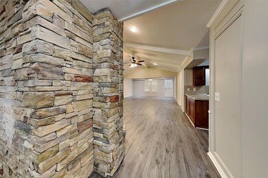 Hall featuring lofted ceiling, crown molding, and 