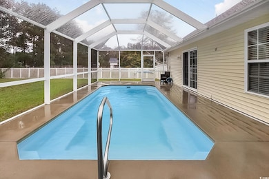 View of pool with a patio area, a yard, and a lana