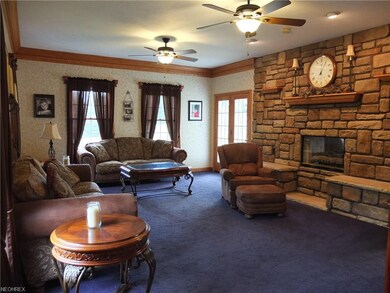The great room has beautiful crown molding and a s