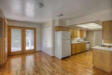 Family room and kitchen with wood floors