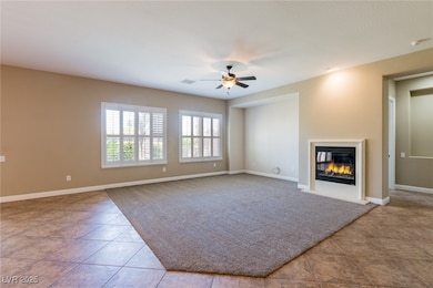 Unfurnished living room featuring tile patterned f